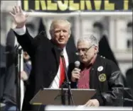  ?? MIKE GROLL — THE ASSOCIATED PRESS ?? In this photo, Donald Trump, left, is joined by Carl Paladino during a gun rights rally at the Empire State Plaza in Albany, N.Y. Paladino, who is currently who is helping to run Donald Trump’s New York campaign, is being challenged for his seat on the Buffalo school board by an 18-year-old high school senior.