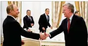  ?? ALEXANDER ZEMLIANICH­ENKO/POOL VIA NEW YORK TIMES ?? Russian President Vladimir Putin (left) shakes hands with National Security Adviser John Bolton during meetings Wednesday at the Kremlin in Moscow.