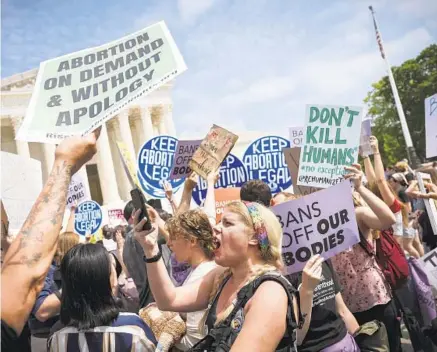  ?? WIN MCNAMEE/GETTY ?? Activists on both sides confront one another in front of the U.S. Supreme Court building Tuesday in Washington, D.C.