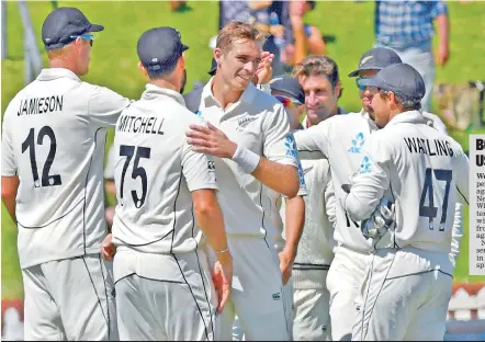  ??  ?? Tim Southee (centre), who took a five-wicket haul, celebrates on Day Three of the opening Test at Wellington.