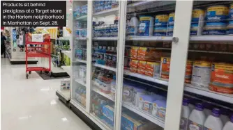  ?? ?? Products sit behind plexiglass at a Target store in the Harlem neighborho­od in Manhattan on Sept. 28.