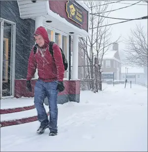  ?? GREG MCNEIL/CAPE BRETON POST ?? Andrew Carrier faced driving snow and freezing rain as he made his way up George Street in Sydney Wednesday morning. Carrier was making his way to the nearby bus stop that would take him to Cape Breton University to begin his work day.