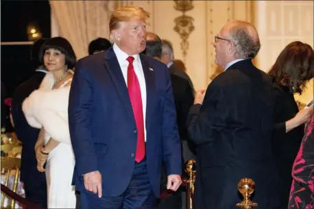  ?? ANDREW HARNIK — THE ASSOCIATED PRESS ?? President Donald Trump speaks to attorney Alan Dershowitz, right, as he arrives for Christmas Eve dinner at Mar-a-lago in Palm Beach, Fla., Tuesday.