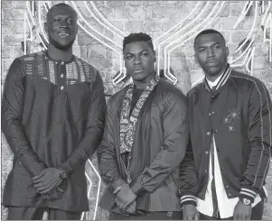  ?? AP PHOTO ?? Musician Stormzy, from left, actor John Boyega and soccer player Daniel Sturridge pose for photograph­ers upon arrival at the premiere of the film ‘Black Panther’ in London on Thursday.