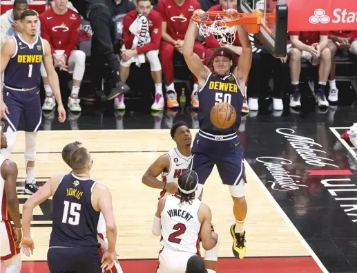  ?? MEGAN BRIGGS/GETTY IMAGES ?? Aaron Gordon of the Nuggets, who scored a game-high 27 points, dunks during the third quarter against the Heat on Friday night. Denver won 108-95.