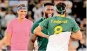  ?? AP ?? Roger Federer wears a South African rugby jersey presented by SA captain Siya Kolisi (centre) while Rafael Nadal looks on ahead of their exhibition match at the Cape Town Stadium in Cape Town on Friday. —