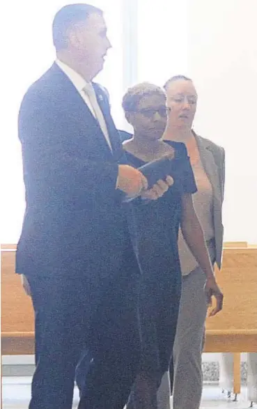  ?? JESSE WARD ?? NYPD Detective Lori Campbell (center) in Brooklyn court on Tuesday, where she was charged with stalking a woman she used to date, and the man her ex-flame later married