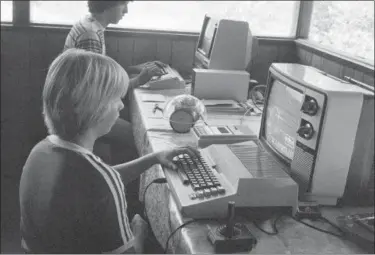  ?? ASSOCIATED PRESS FILE PHOTOS ?? Greg Berman, 12, of Santa Barbara sits at computer console at California Computer Camp near Santa Barbara. Today’s grandparen­ts may have fond memories of the “good old days,” but history tells us that adults have worried about their kids’ fascinatio­n with new-fangled entertainm­ent and technology since the days of dime novels, radio, the first comic books and rock n’ roll.