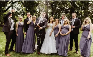  ??  ?? CASEY & LUKE
Pop those bubbles! Celebrate with a spray of the liquid good stuff all over your bridal party! Image Jess McGhie Photograph­y.