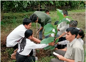 ??  ?? The level-3 station of the Nam Ou project plants trees at the local campus for the rural, disadvanta­ged students.