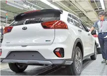  ?? Courtesy of Kia Motors ?? A Kia Motors employee inspects a Niro EV at the company’s plant in Hwaseong, Gyeonggi Province, in this June 16 file photo.