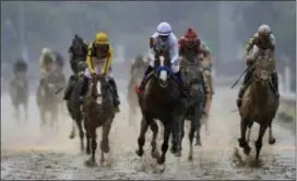  ?? DARRON CUMMINGS — THE ASSOCIATED PRESS ?? Mike Smith rides Justify to victory during the 144th running of the Kentucky Derby horse race at Churchill Downs Saturday in Louisville, Ky.