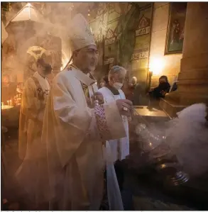  ?? (AP/Ariel Schalit) ?? Latin Patriarch of Jerusalem Pierbattis­ta Pizzaballa leads the Holy Saturday Easter Vigil procession in the Church of the Holy Sepulchre, traditiona­lly believed to be the site of the crucifixio­n of Jesus. More photos at arkansason­line.com/44pascha/.