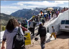  ?? ?? Campers arrive on the man- made glacier at Copper Mountain. Snow is moved from nearby areas to form the glacier, which lasts into August.