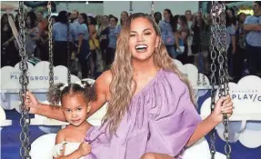  ?? GETTY IMAGES ?? Chrissy Teigen and daughter Luna enjoy Pier 94 in New York City.