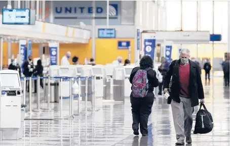  ?? NAM Y. HUH/AP ?? Travelers walk through a terminal at O’Hare Internatio­nal Airport in Chicago in October 2020.