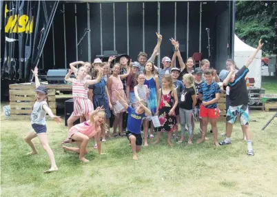  ?? PHOTO: TOM KITCHIN ?? Kids for kids . . . Ben Whitaker (back, centre) celebrates the success of The (Little) Big Day Out in Alexandra, surrounded by St Gerard’s School choir and other children who performed and attended.