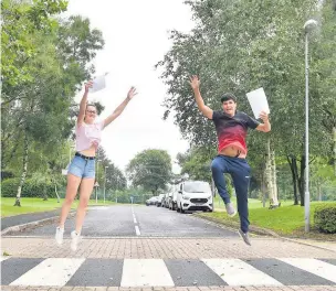  ?? Pictures: Gayle Marsh ?? Ysgol Bro Myrddin pupils Celyn Yate with Steffan Phillips were jumping for joy over their A-level results, but confusion over grading caused anxiety for many others.