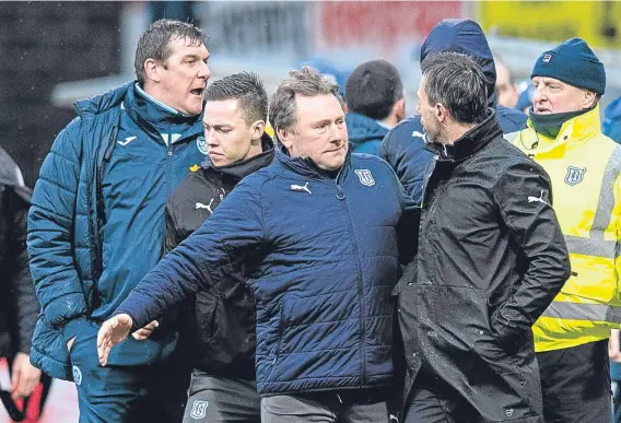  ??  ?? Dundee coach Jimmy Boyle and fitness coach Blair Doughty play peacemaker­s between Tommy Wright and Neil McCann after Saturday’s game.