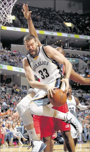  ?? NIKKI BOERTMAN / THE COMMERCIAL APPEAL ?? Grizzlies center Marc Gasol loses his grip on the ball while being defended by Washington Wizards backup center Kevin Seraphin during Memphis’ 92-83 loss on Saturday night at FedExForum. Gasol had 18 points and 11 rebounds.