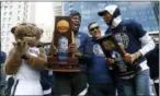  ?? PATRICK SEMANSKY — THE ASSOCIATED PRESS ?? Villanova forward Eric Paschall, from second from left, head coach Jay Wright and guard Mikal Bridges celebrate during a rally following a parade for the team’s NCAA college basketball championsh­ip, Thursday in Philadelph­ia. Villanova defeated Michigan...