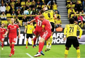  ?? — AFP photo ?? Dortmund’s forward Haaland (centre, top) heads the ball to score the 2-0 during the German Bundesliga match against FC Union Berlin in Dortmund, western Germany.