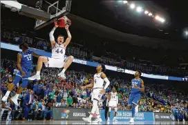  ?? JAMIE SQUIRE / GETTY IMAGES ?? Kansas’ Mitch Lightfoot dunks over Seton Hall’s Myles Powell during their NCAA Tournament second-round matchup Saturday. The top-seeded Jayhawks won 83-79 and will face No. 5 seed Clemson in the Sweet 16 on Friday.