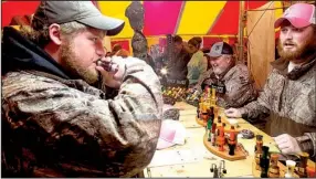  ?? Arkansas Democrat-Gazette/MELISSA SUE GERRITS ?? Sam Henry tries out a duck call Saturday from Timber Boss Duck Calls of Bald Knob, while Nathan Leopard (right) assists him during the 2015 World’s Championsh­ip Duck Calling Contest and Wings Over the Prairie Festival in Stuttgart. More photos are...