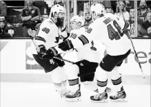  ?? JOHN LOCHER THE ASSOCIATED PRESS ?? Sharks’ Logan Couture, centre, celebrates after scoring the winning goal against the Vegas Golden Knights. San Jose won the contest, 4-3.