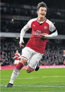  ?? /Reuters ?? On form: Mesut Ozil celebrates scoring for Arsenal in midweek , a sight Manchester United manager Jose Mourinho does not want to see on Saturday.