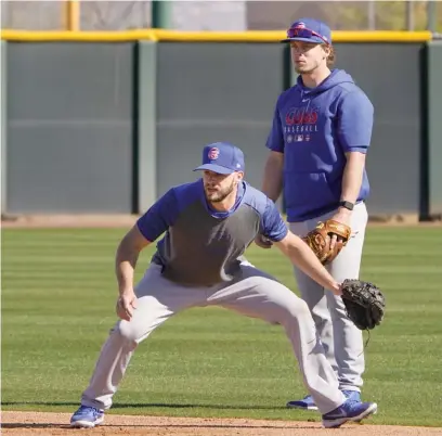  ?? JAE C. HONG/AP ?? David Bote beat out Nico Hoerner (rear) for the Cubs’ starting second-base job with a strong spring training.