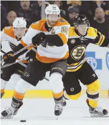  ?? AP PHOTO ?? IN PURSUIT: Bruins defenseman Torey Krug (right) chases down Philadelph­ia Flyers captain Claude Giroux during the first period yesterday at the Garden.