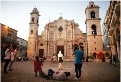  ??  ?? Yazuli Lloret, 15, poses for a photograph­er at the Cathedral Square in Havana, Cuba. Cuba’s economy shrank 0.9 per cent this year in tandem with the crisis in key trading partner Venezuela, President Raul Castro told the National Assembly in a closed-door speech, predicting a slightly brighter outlook for 2017. — Reuters photo