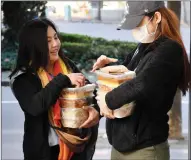  ??  ?? Internatio­nal students at the Melbourne City Institute of Education collecting their weekly free meals.