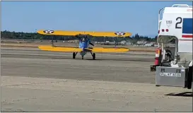  ?? ?? A Boeing Stearman biplane piloted by Andrew Lohmar moves onto the runway Wednesday at the Chico Municipal Airport with Vietnam veteran Danny Flowers as a passenger in Chico.