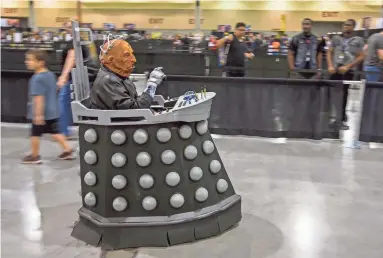  ??  ?? Jack Morgam, dressed as Lord Davros from Doctor Who, rides around during Day 4 of Phoenix Comic Fest on Sunday at the Phoenix Convention Center.