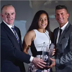  ??  ?? Rianna receiving her award from Tom Dennigan, left, of Continenta­l Tyres and Republic of Ireland manager Colin Bell.