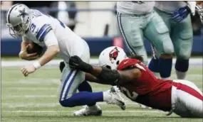  ?? BRANDON WADE — THE ASSOCIATED PRESS ?? Ed Stinson sacks Brandon Weeden during the second half of the Arizona Cardinals’ 28-17 victory over the Dallas Cowboys Sunday. The Cardinals improve to a league-best 7-1 with the win.