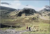  ?? PICTURES: PA WIRE. ?? PLANET’S FINEST: Hillwalker­s set out towards the Three Sisters mountain range in Glencoe, Scotland.