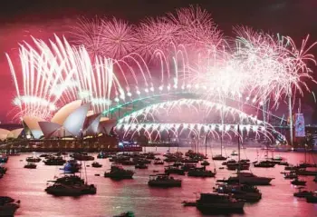  ?? DAVID GRAY/GETTY-AFP ?? New Year’s Eve fireworks light up the sky Sunday over the Opera House and Harbor Bridge in Sydney.