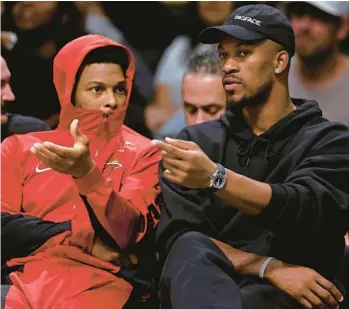  ?? ADAM HUNGER/AP ?? Heat forward Jimmy Butler, right, talks to Kyle Lowry on the bench Nov. 25 against the Nets in New York.