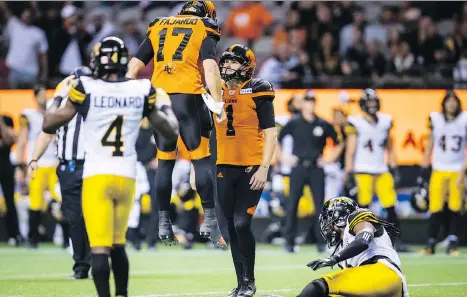  ?? DARRYL DYCK/THE CANADIAN PRESS ?? B.C. Lions kicker Ty Long and Cody Fajardo celebrate after Long kicked the game-winning field goal during the second overtime of a thrilling CFL game at B.C. Place Stadium last Saturday. The teams are preparing to meet again this weekend in Hamilton.