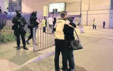  ??  ?? Una pareja se abraza afuera de la Arena Manchester. Muchos padres de familia esperaban el fin del concierto para recoger a sus hijos.