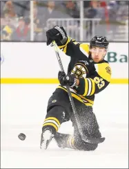  ?? Maddie Meyer / Getty Images ?? The Bruins’ Brad Marchand makes a pass as he falls to the ice during the first period against the Kings on Tuesday in Boston.