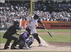  ?? AP PHOTO/CARLOS OSORIO ?? Detroit Tigers designated hitter Miguel Cabrera connects for his 3,000th hit during the first inning of the first baseball game of a doublehead­er against the Colorado Rockies, on Saturday in Detroit.