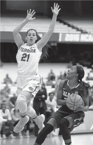  ??  ?? Florida guard Eleanna Christinak­i (21) defends against Albany guard Shereesha Richards during Albany’s 61-59 win in the NCAA women’s tournament Friday.