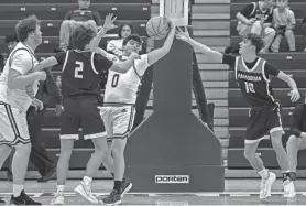  ?? PETER ACKERMAN ?? RBC’s Colin Cavanaugh and Manasquan’s Luke Roy battle for a rebound during a WOBM Christmas Classic game on Dec. 28.