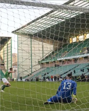  ??  ?? Ryan Porteous wheels away to celebrate after coolly slotting the ball past Liam Kelly to win the shootout for Hibs