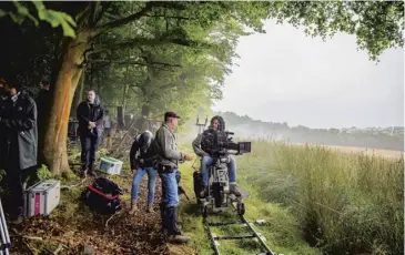  ??  ?? Brad Pitt filming a scene in Glasgow for World War Z in 2011, above left; David Mackenzie with his cast and crew filming Outlaw King in the summer of 2018, above