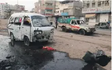  ?? AFP ?? People walk past damaged cars at the entrance of Al Thawra Hospital after an attack by Houthis on Thursday